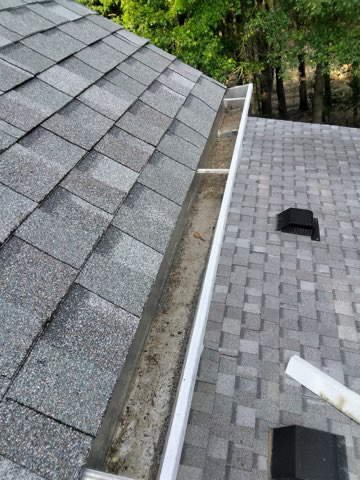 Repaired: a new gutter run installed along the eave, set to pitch and sealed at the joints, catching the water this section of roof had been shedding onto the wall