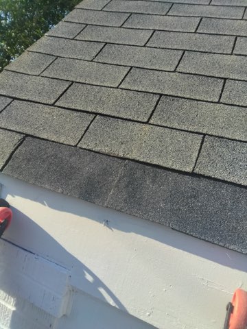Repaired shingles at the eave, blended back into the roof