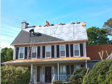 Synthetic underlayment down and the crew loading and setting the new shingle field