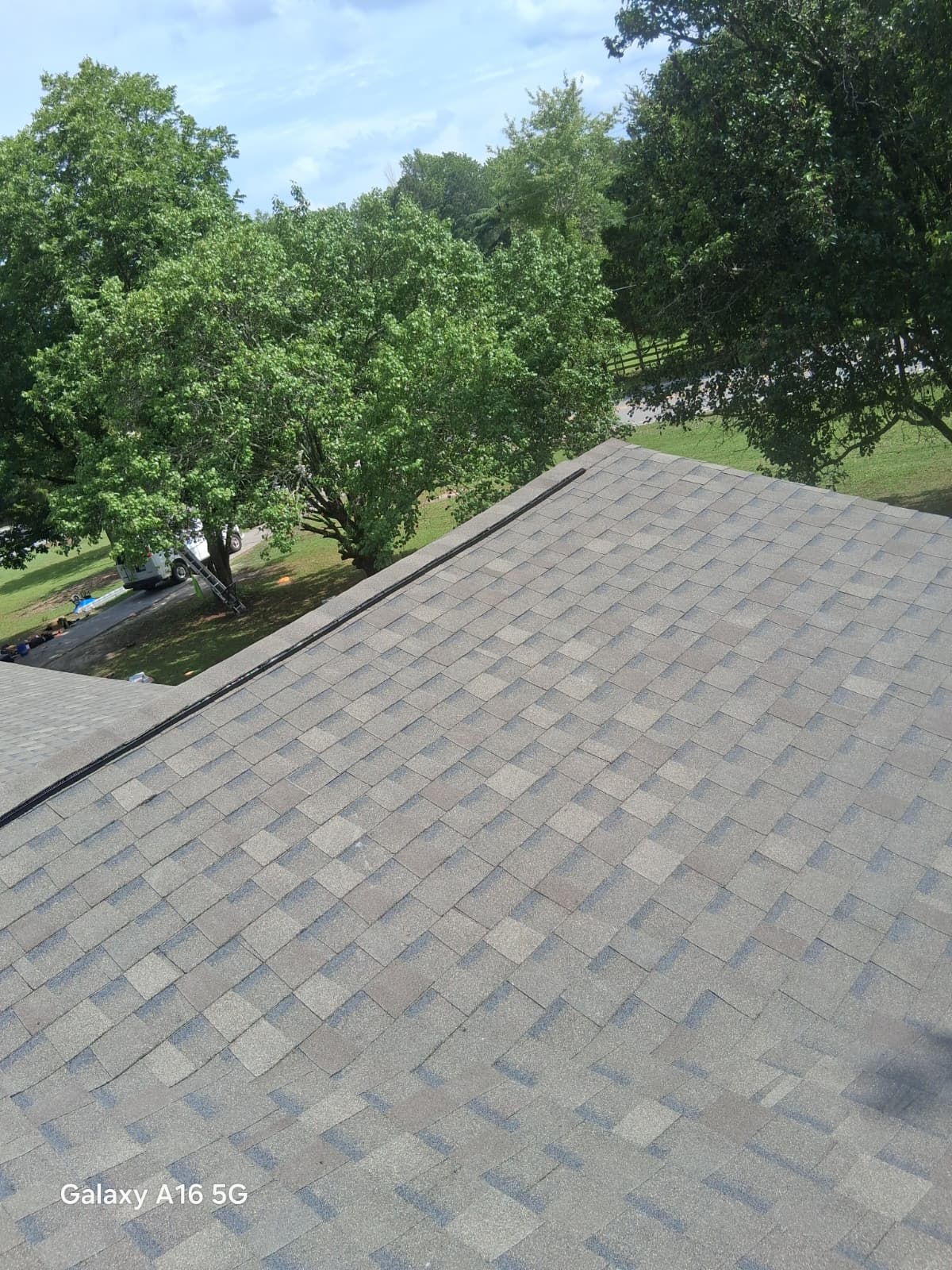 Finished: a clean new architectural shingle slope replacing the old worn roof