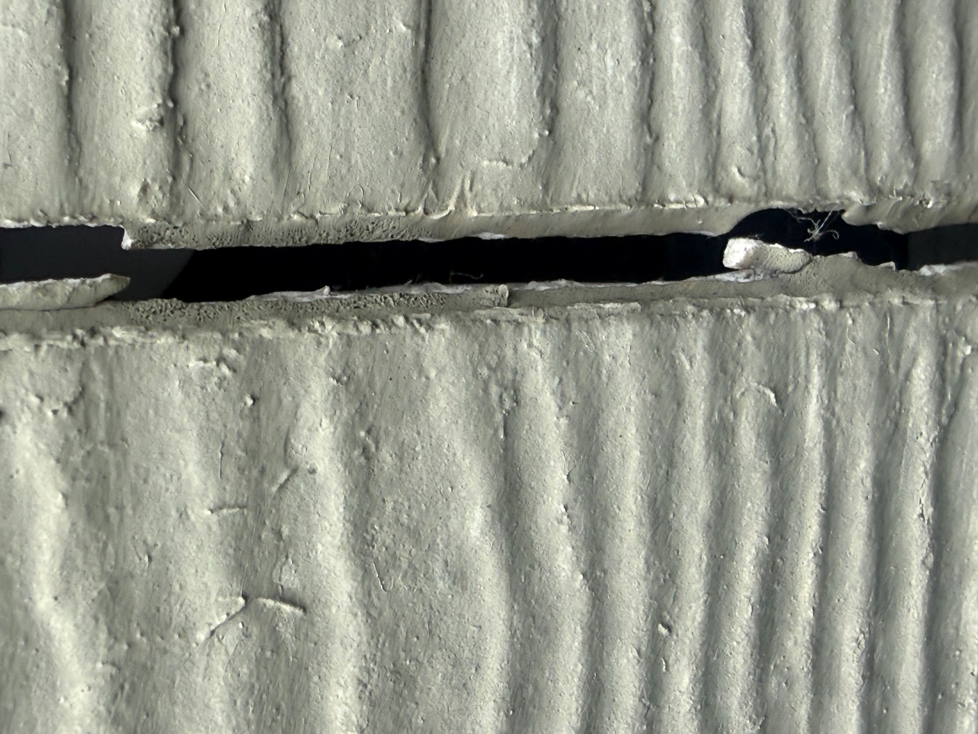 Failed joint exposing the wall behind the siding