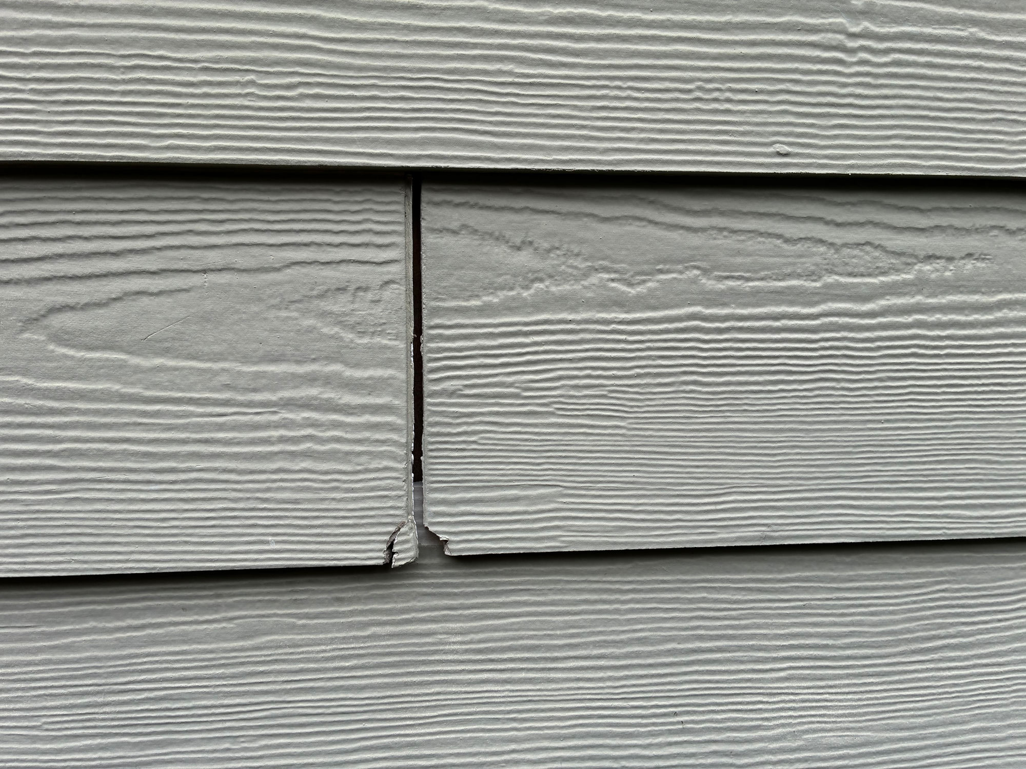 Damaged board end beside the window trim