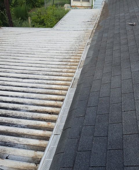Repaired: the gutter cleared out and the guard reset along the edge where the shingle roof meets