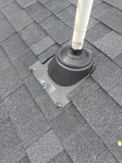 Repair: a new rubber boot and metal base plate set around the plumbing vent, screwed down with