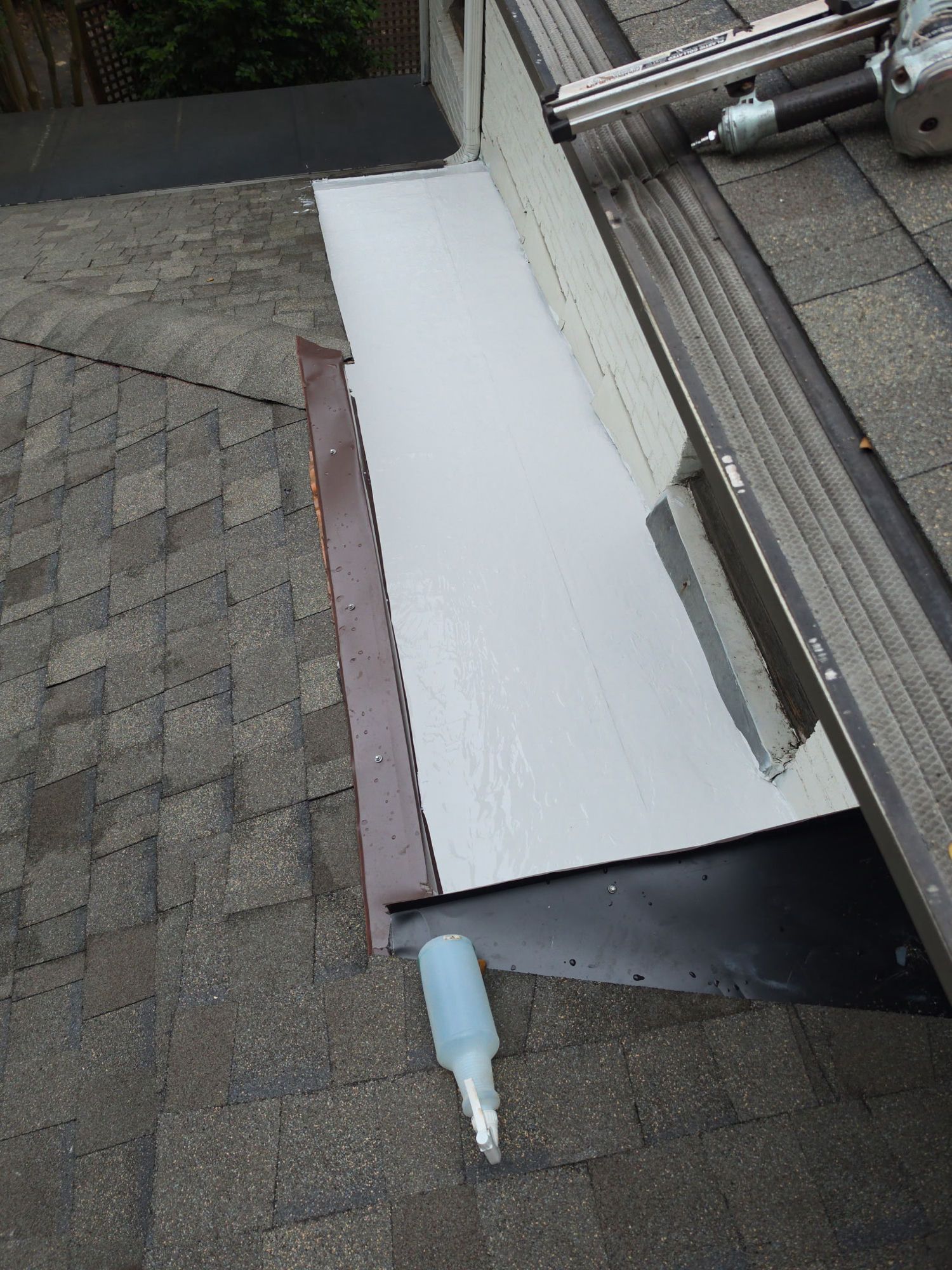 Installation underway: a self-adhered waterproofing membrane run up the roof-to-wall joint with new