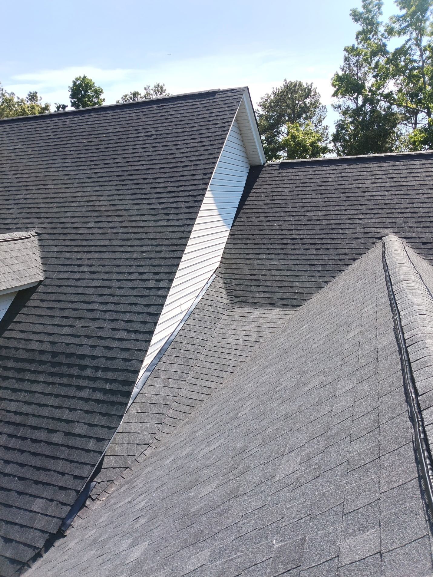 Finished: where the gable wing meets the main roof, the new shingles run through the valley on both