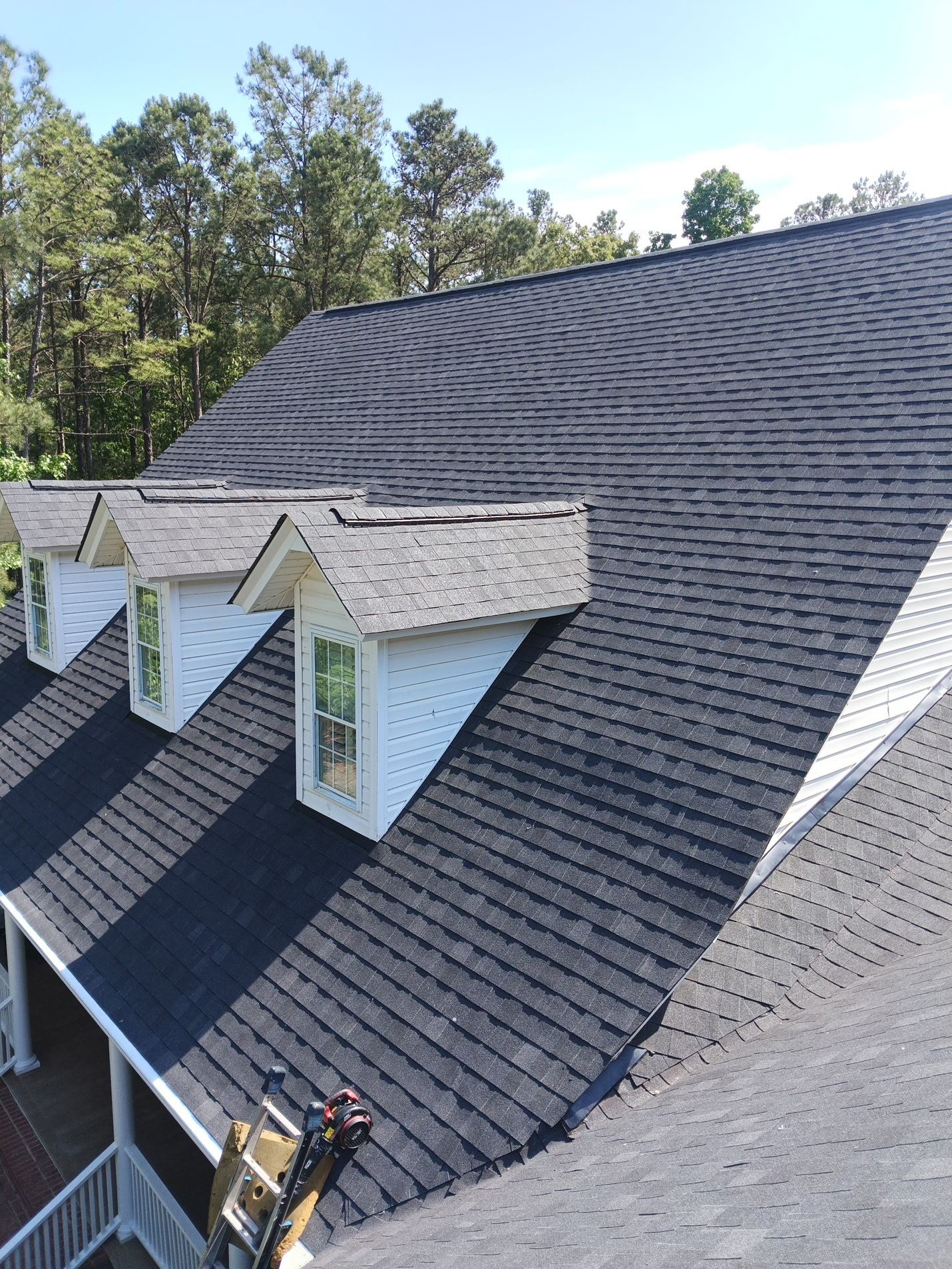 Finished: the new shingle field across the rear slope with all four dormers reroofed and their