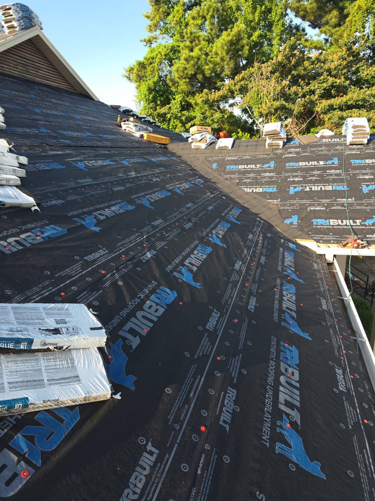Installation underway: TriBuilt synthetic underlayment fastened down over the deck with capped