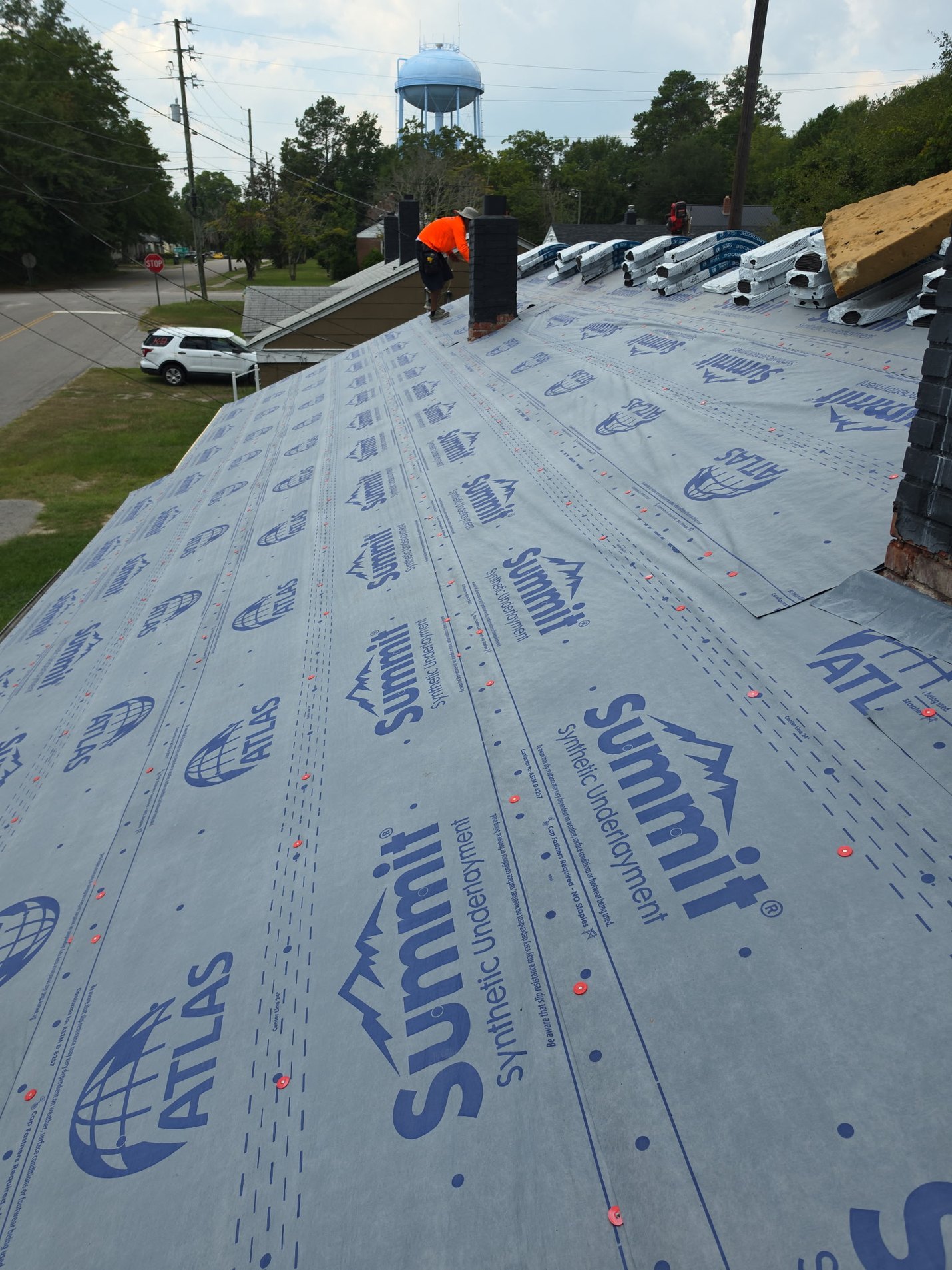 Installation underway: Summit synthetic underlayment fastened down over the deck with capped nails