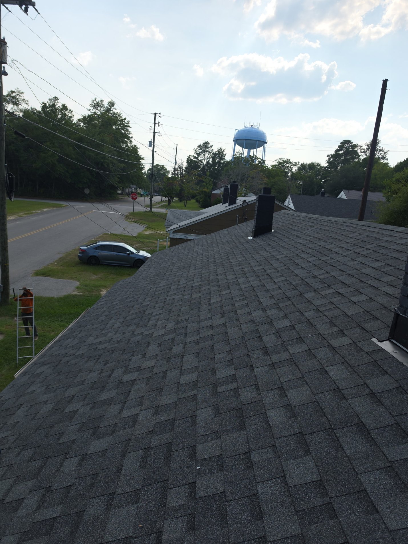 Finished: the front slope in new architectural shingles, with fresh flashing worked in at the