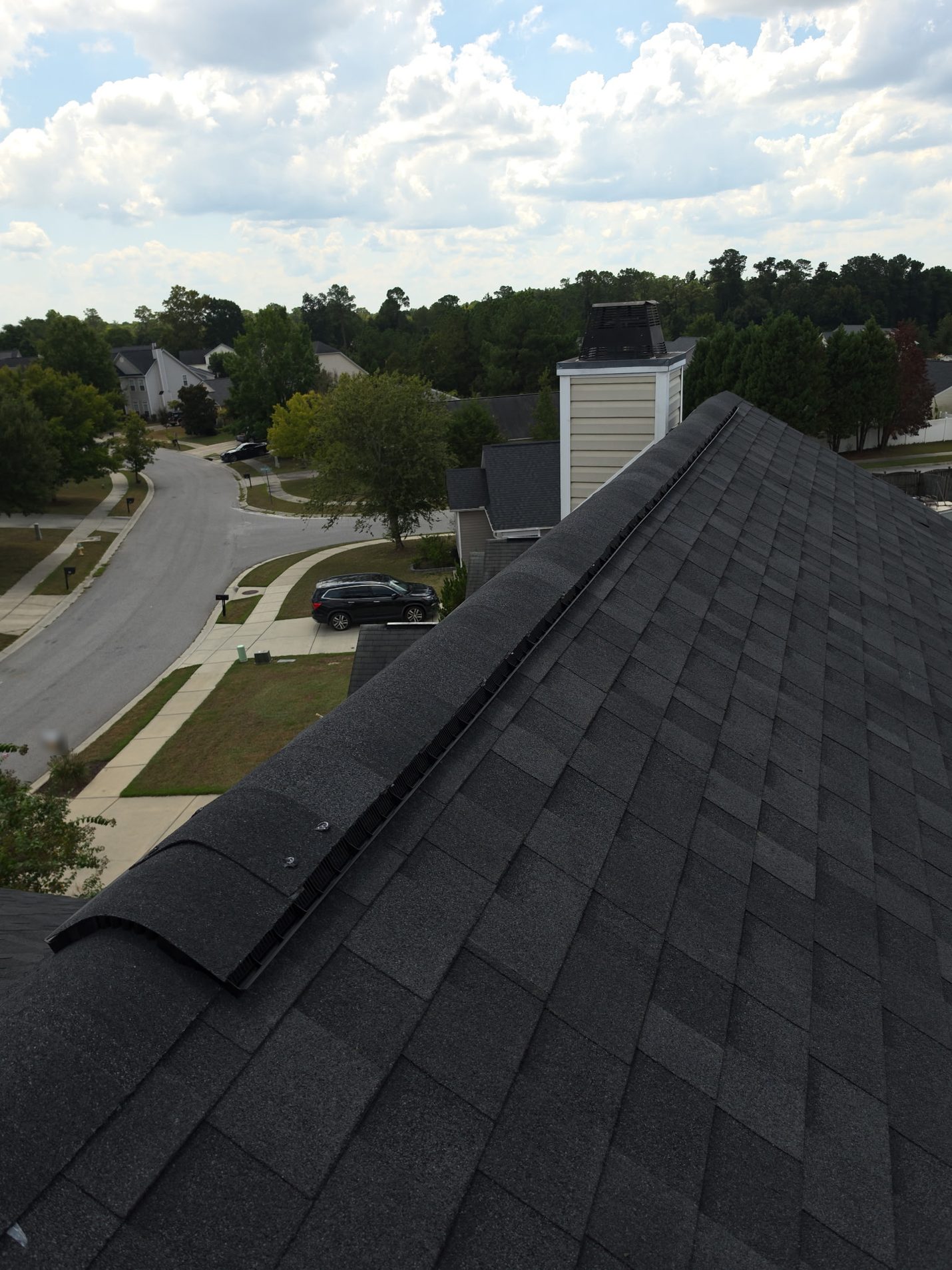 New architectural shingles on both slopes, with ridge cap shingles going back on over the ridge
